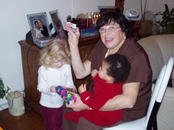 Nanna displays the nifty origami card, while Rachel instructs Kayla in the fine art of gift unwrapping