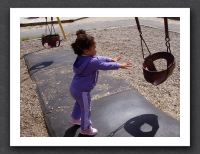 Kayla pushes the swing