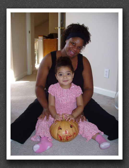 A girl, her mommy, and her pumpkin