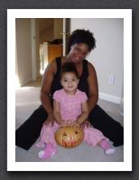 A girl, her mommy, and her pumpkin